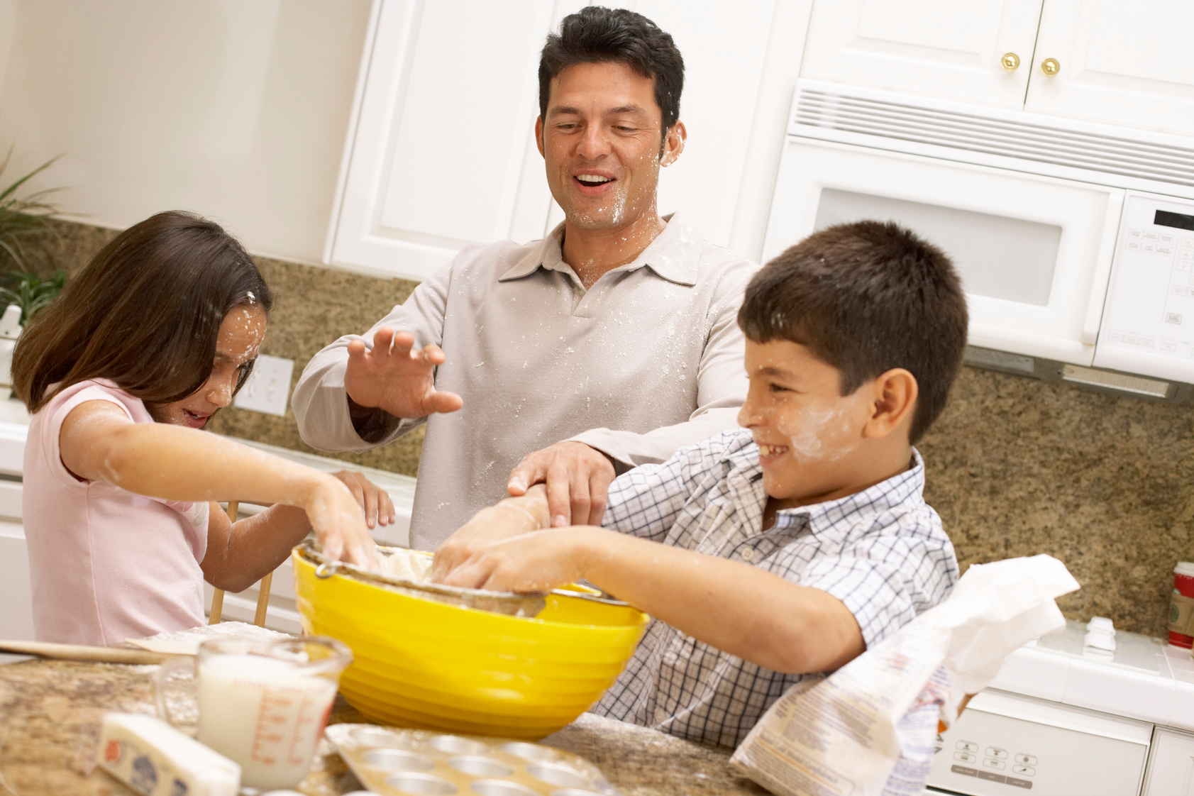 Father and children baking